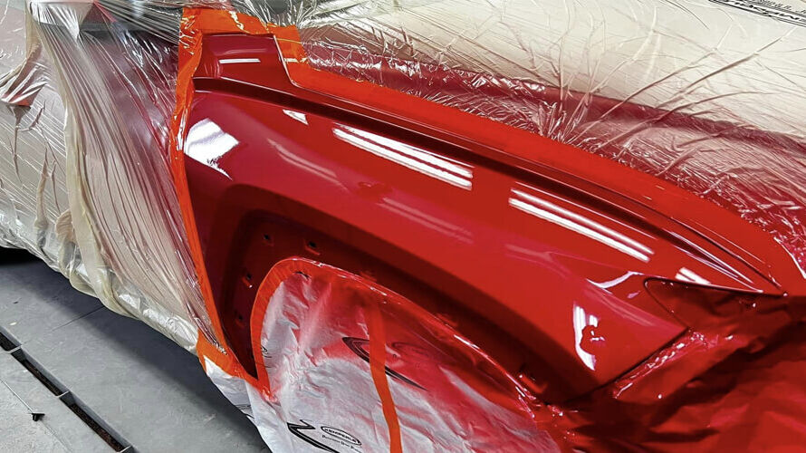 Detailer applying polish to enhance Clear Coat Car Paint shine