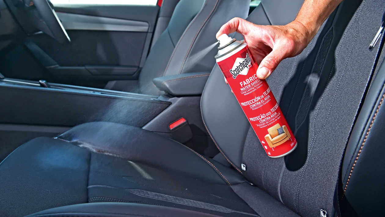 What Is Fabric and Upholstery Protection in Mobile Detailing? 1 Technician applying spray for Fabric and Upholstery Protection in Mobile Detailing