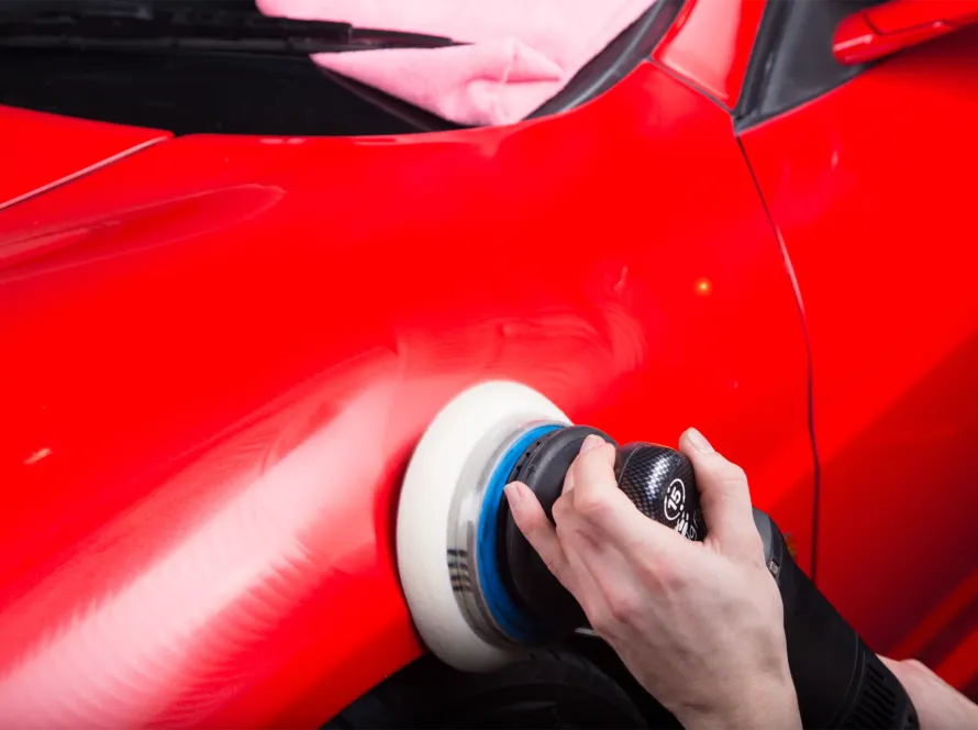 Detailer inspecting Swirl Marks Car Paint before paint correction process