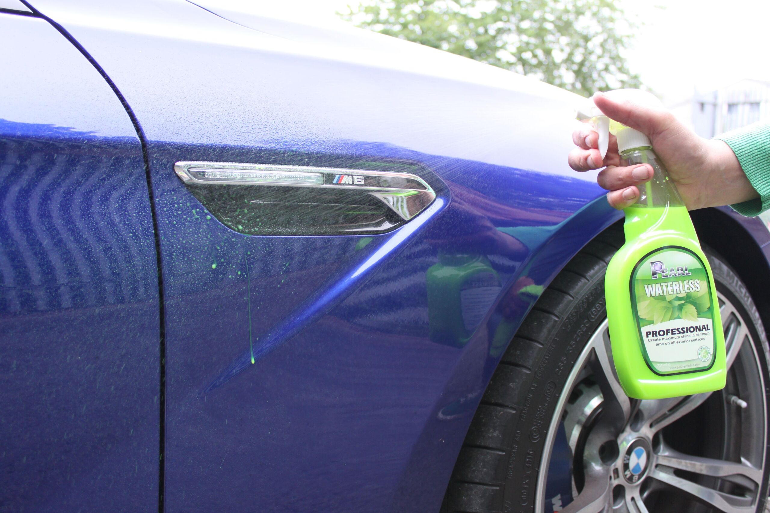 Pros and Cons of Waterless Cleaning 1 Detailer performing Waterless Car Cleaning with spray and microfiber towel