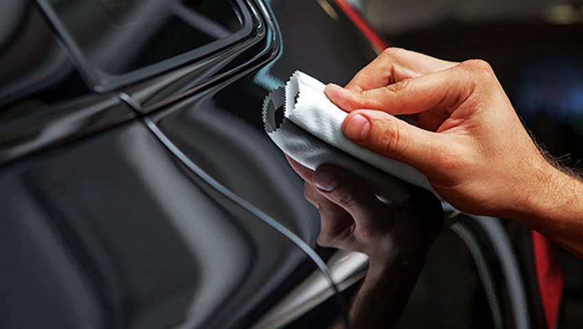 Detailer explaining Ceramic Coating Warranty to car owner