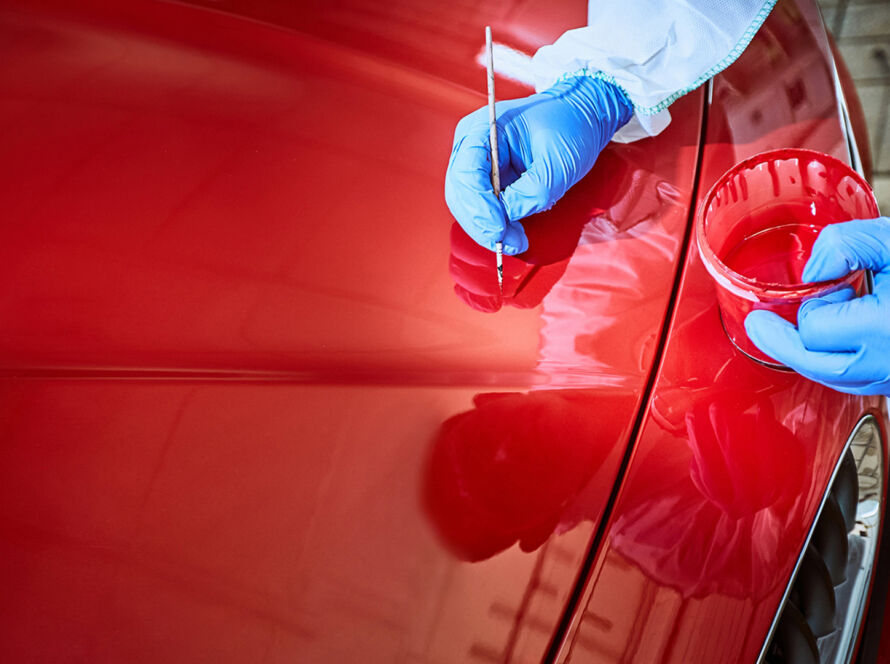 Detailer inspecting Paint Defects under strong light before correction process