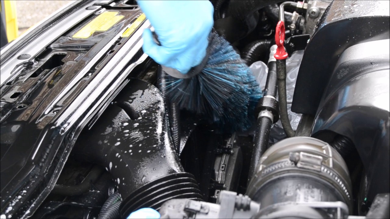 Step-by-Step Guide to Engine Bay Cleaning 1 Mechanic demonstrating Engine Bay Cleaning Guide with safe detailing tools